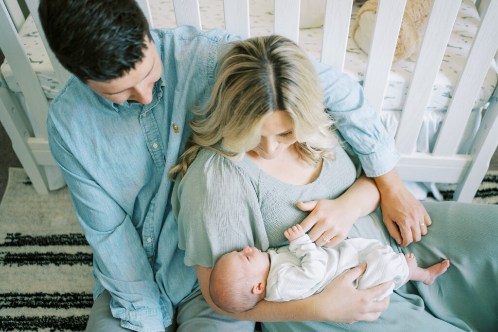 new parents holding newborn baby boy during newborn session