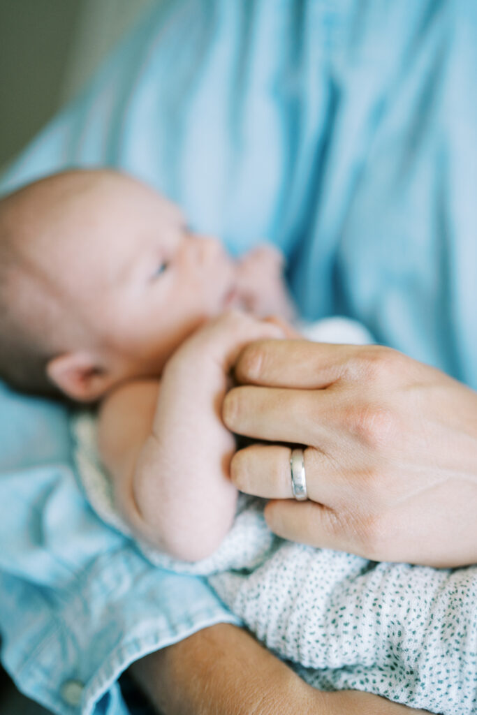 baby holding dad’s hand at Indianapolis coffee shop