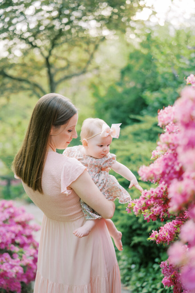 baby smiling surrounded by plants and flowers at Indianapolis conservatory