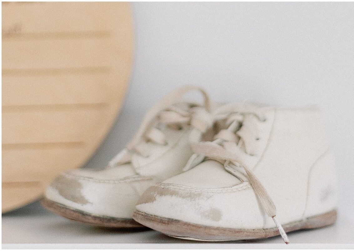 baby boots sitting on dresser during a home newborn photography session