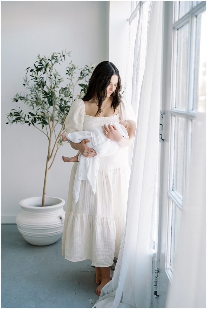 mother holding baby during studio newborn photography session