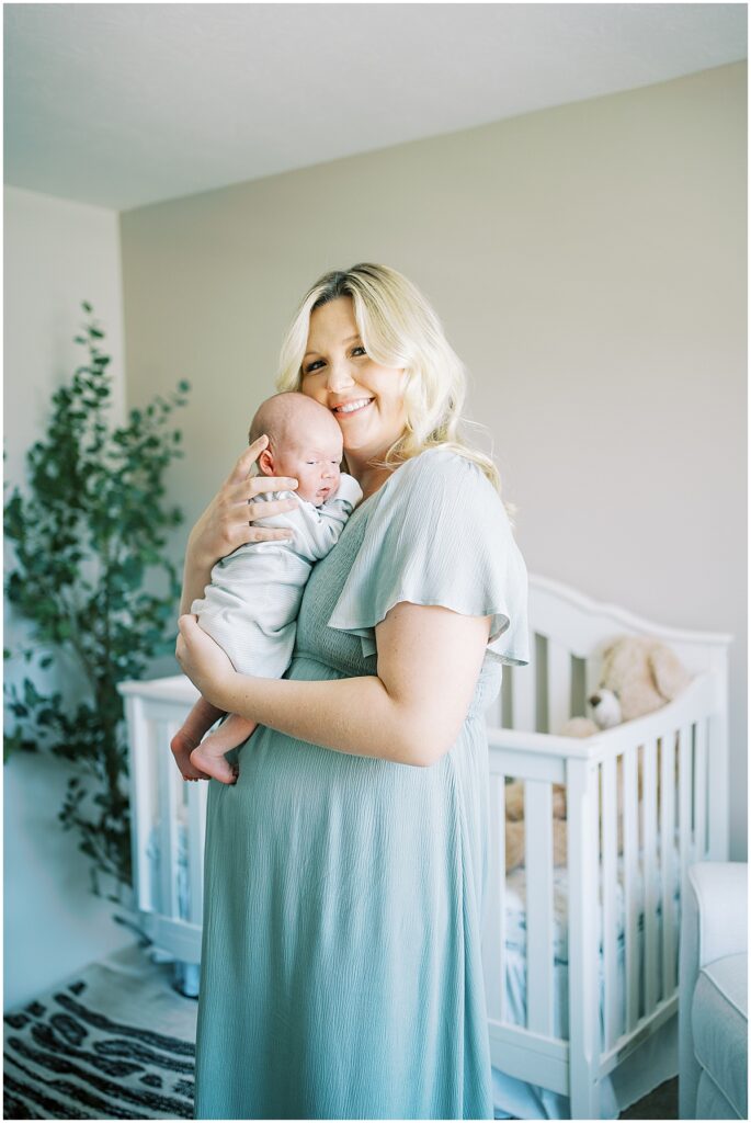 mother snuggling baby during newborn photography session