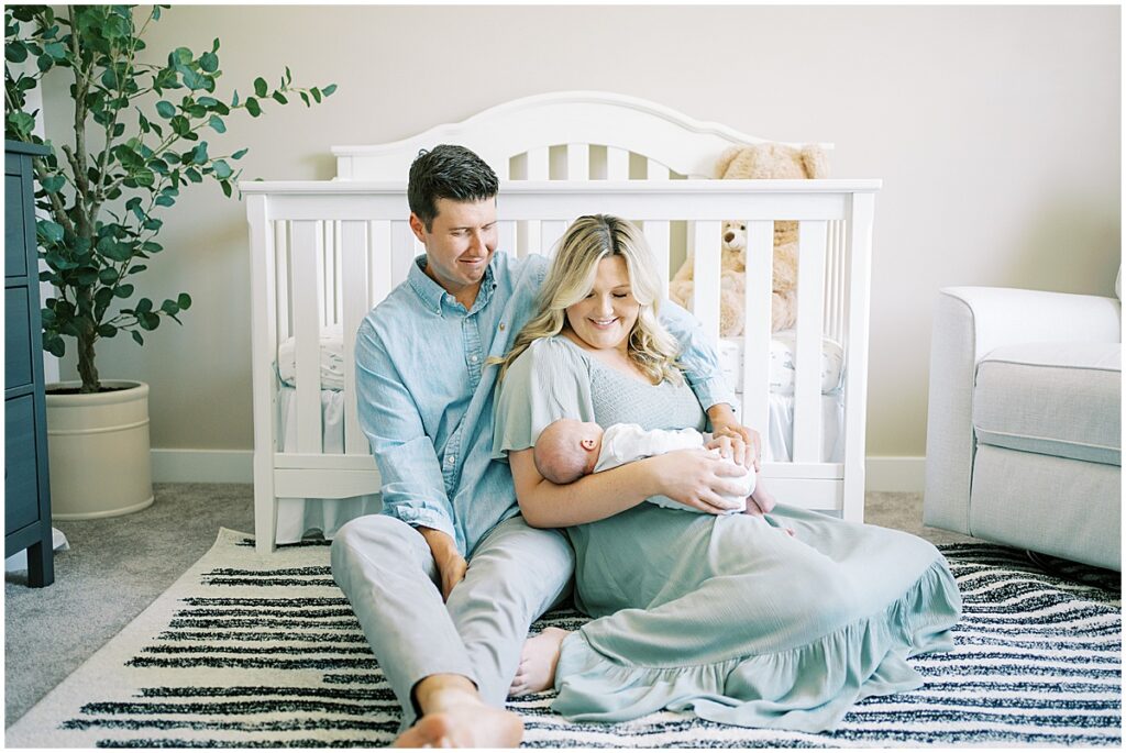 parents holding baby during home newborn photography session