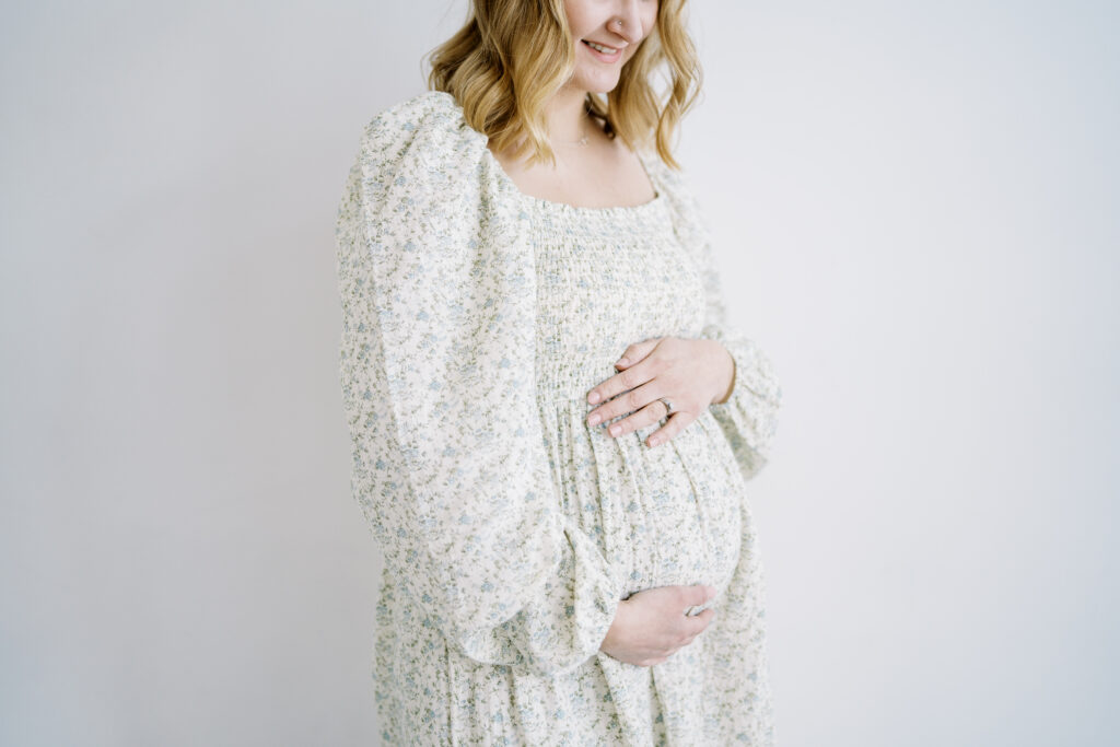 pregnant woman holding stomach during a maternity session