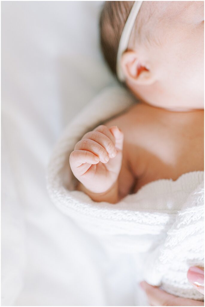 Details of newborn hand during at home photo session in Fishers Indiana
