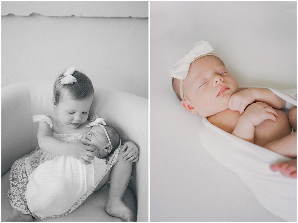Sister in cream floral dress holds newborn during Indianapolis studio session