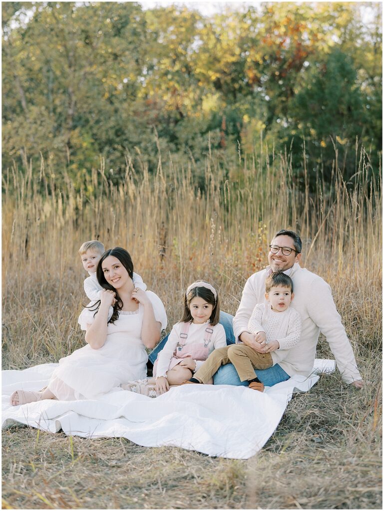 Family sit on white blanket at Carmel Indiana photo session