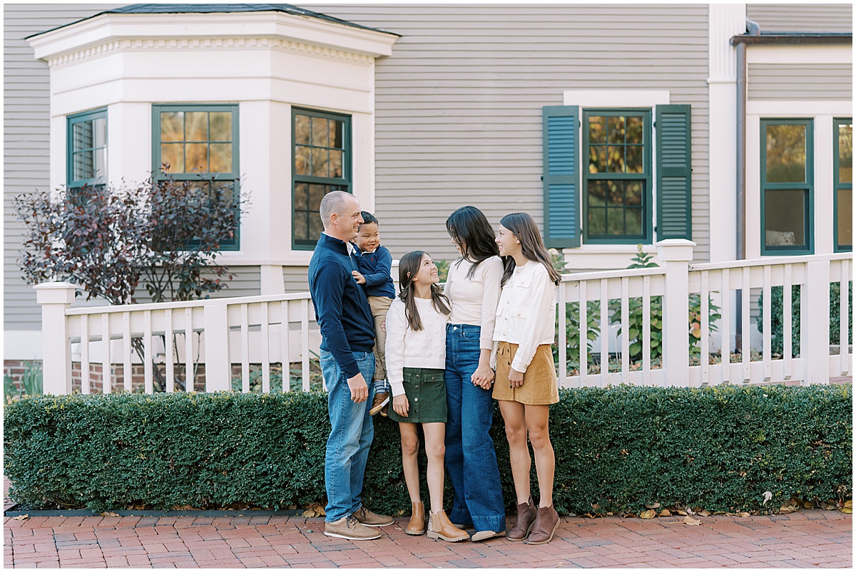 Family takes fall photos in front of Ambassador House in Fishers Indiana