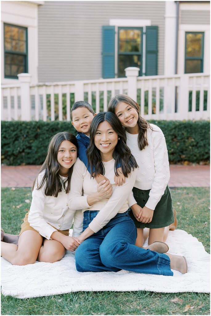 Mother sits with children during fall family photos in Indianapolis