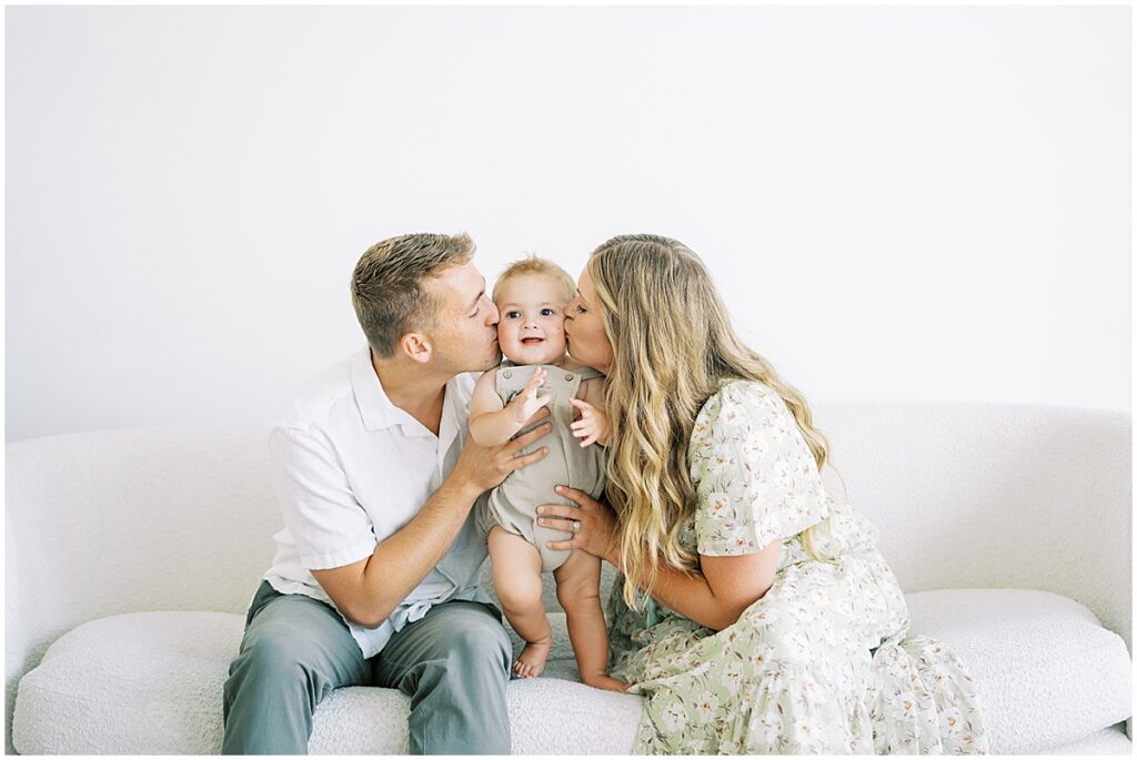 Parents kiss son during milestone family session