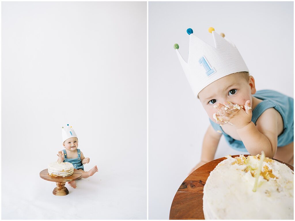 Baby in blue eats white cake during first birthday photos