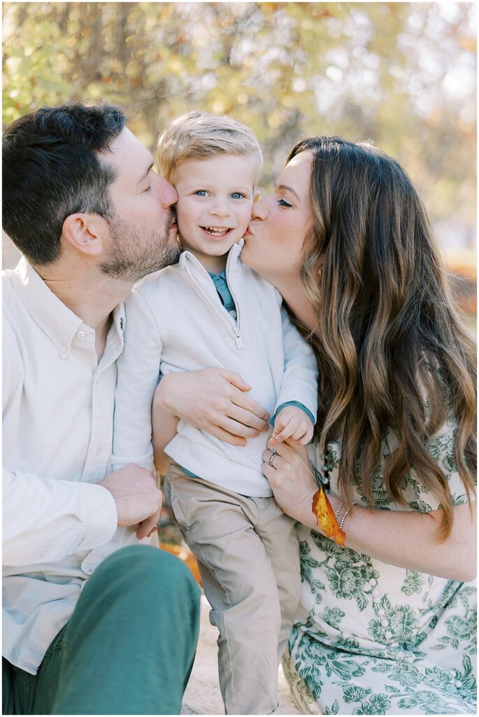 Parents kiss son during fall mini session in Indianapolis