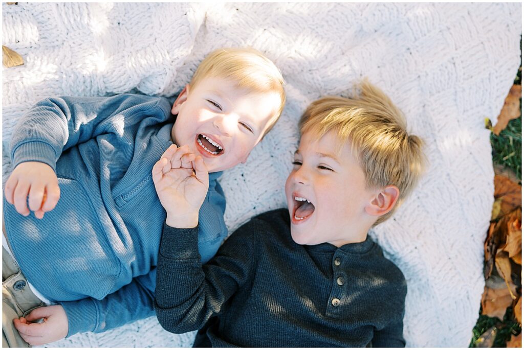 Brothers in blue laugh during mini fall session