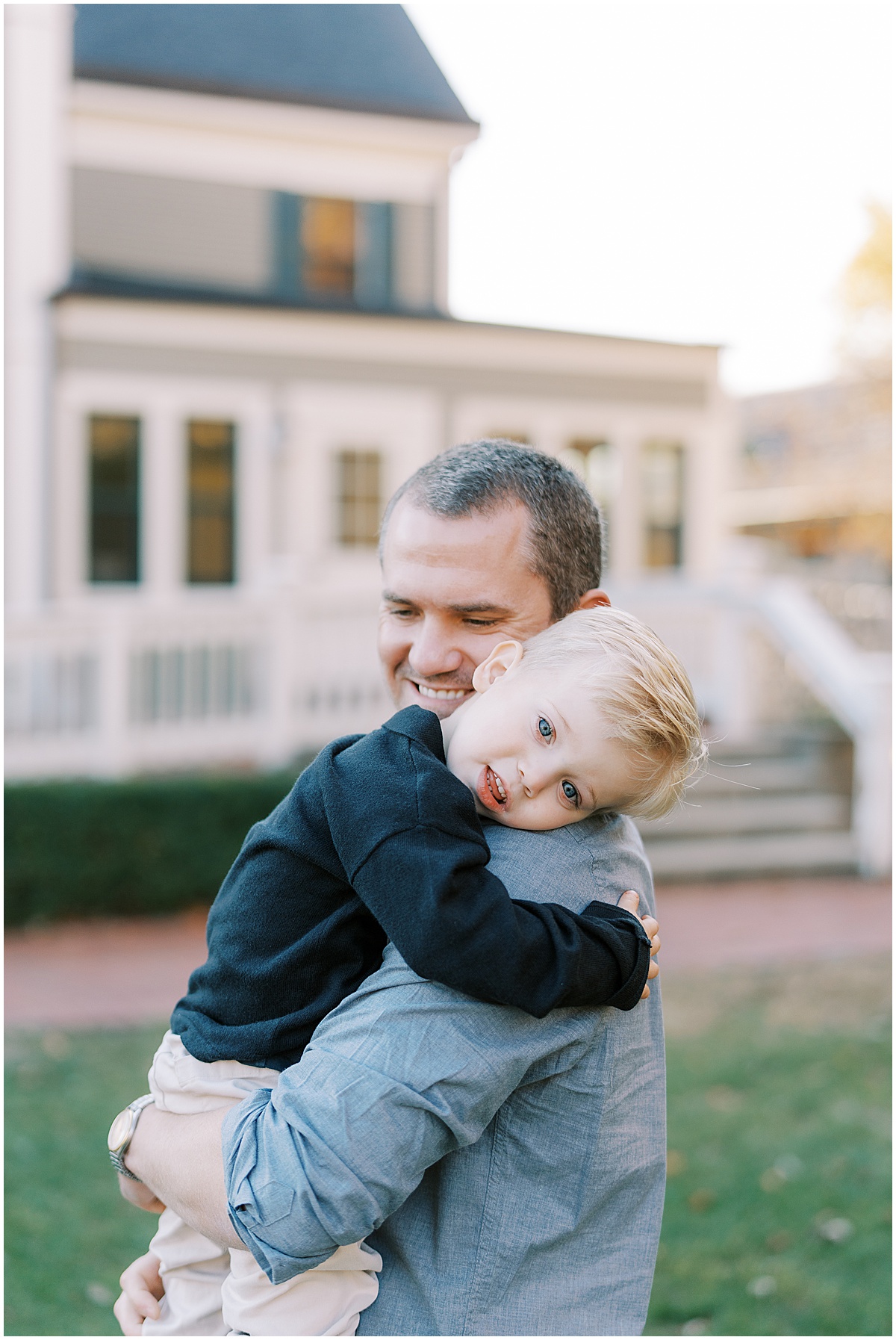 Dad and son hug during fall mini session at The Ambassador House