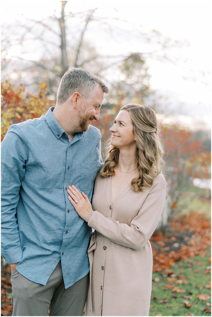 Couple by colorful leaves at fall mini photo session