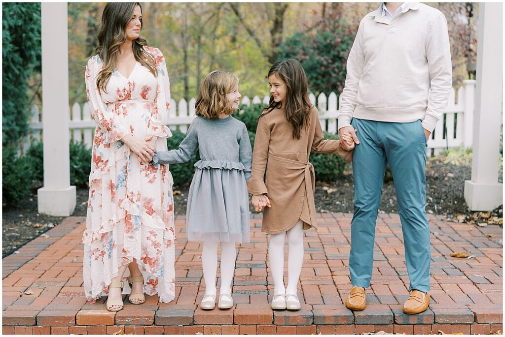 Parents with sisters on brick path at The Ambassador House