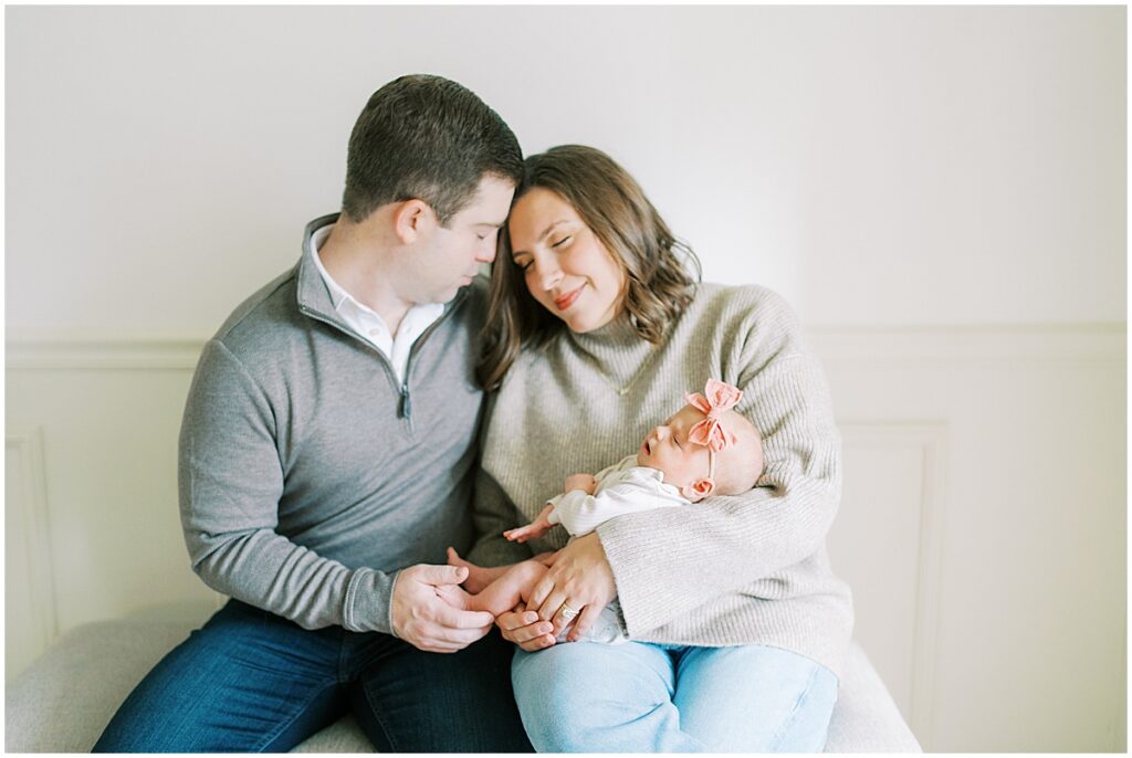 Parents of newborn take a quiet moment during newborn lifestyle session in Indianapolis