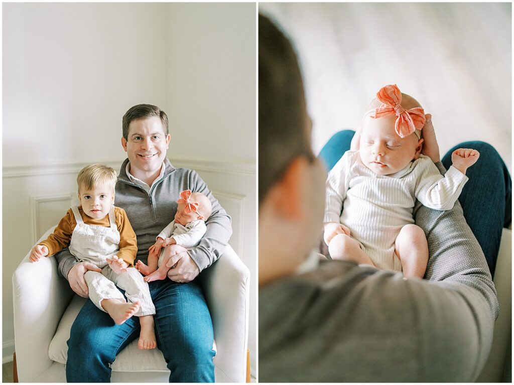 Dad holds newborn in pink bow during Indianapolis studio photos
