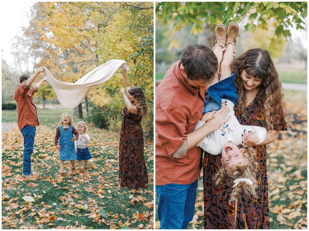 Parents play in leaves with children during at home family photos