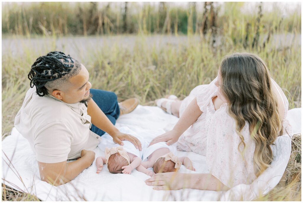 Twin newborn girls on blanket during family photo session in Carmel