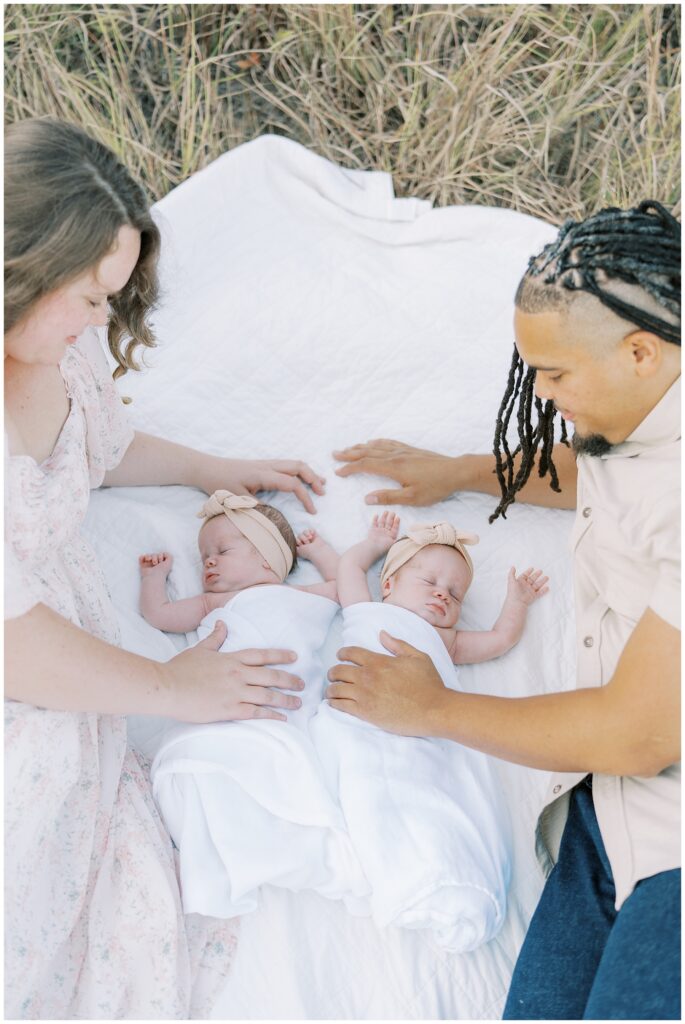 Twin newborn girls on blanket during family photo session in Carmel