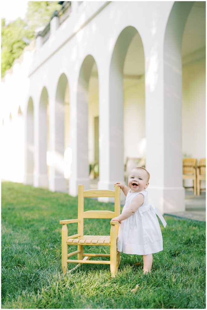 First birthday milestone session outside with tiny chair