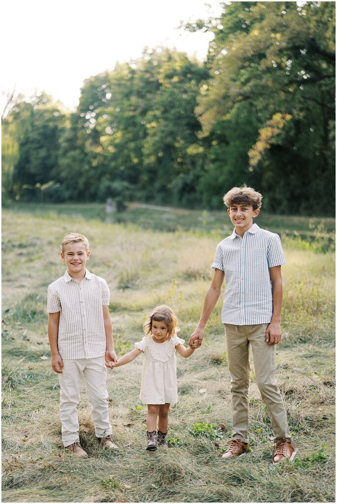 Brothers hold younger sisters hands during family photos in Indianapolis