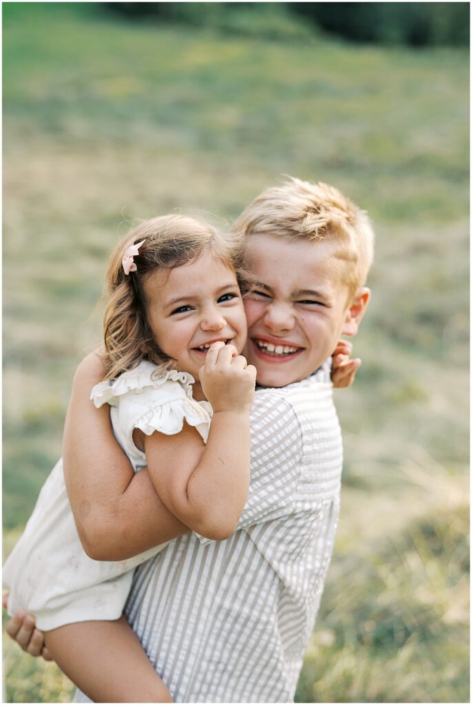Siblings laugh together at Holcomb Gardens Family Photos in Indianapolis, Indiana