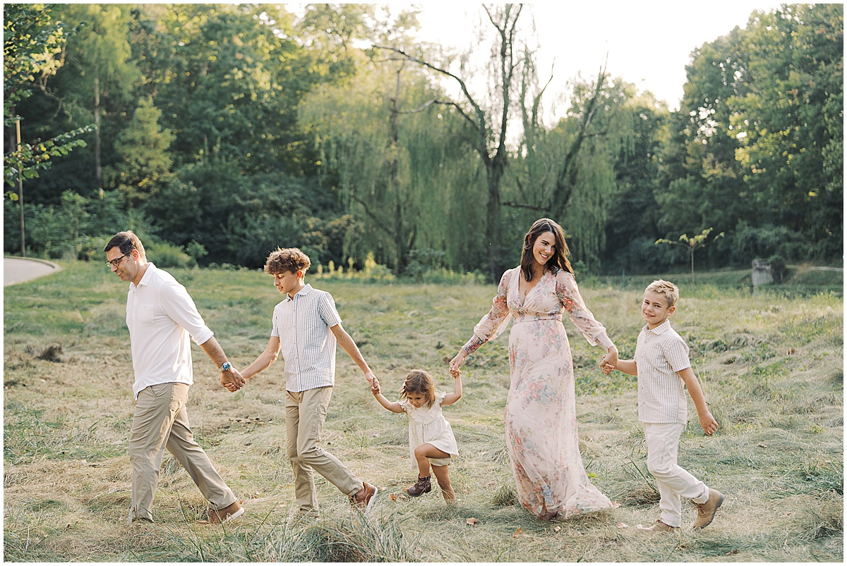 Soon to be family of six laugh during Holcomb Gardens Family Photos in Indianapolis, Indiana