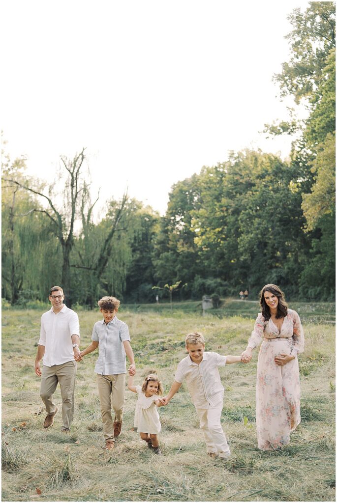Soon to be family of six laugh during Holcomb Gardens Family Photos in Indianapolis, Indiana